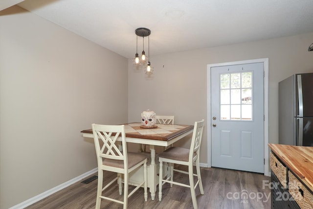 dining space with dark wood-type flooring