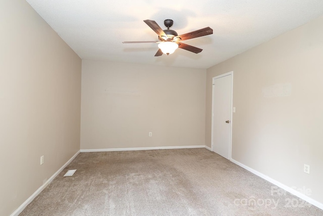 empty room featuring carpet flooring and ceiling fan