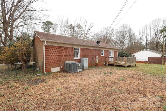 rear view of property featuring a deck and central air condition unit