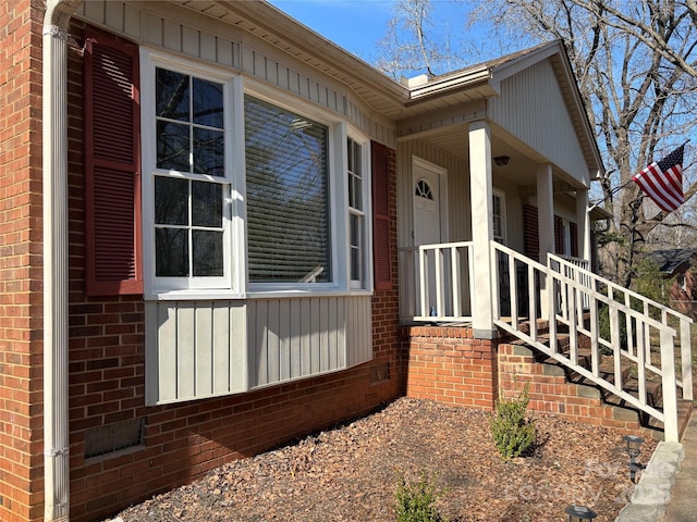 view of property exterior with covered porch and brick siding