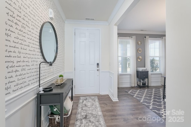 entrance foyer with dark hardwood / wood-style floors, crown molding, and brick wall