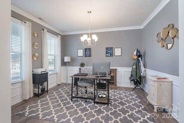 office area featuring dark hardwood / wood-style flooring, ornamental molding, and an inviting chandelier