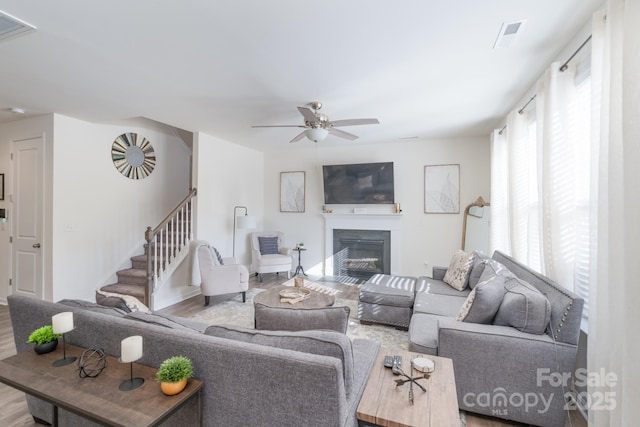 living room with hardwood / wood-style flooring and ceiling fan