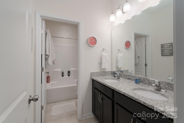 bathroom with tile patterned flooring, vanity, and shower / bathtub combination