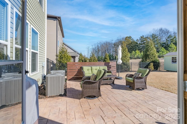 view of patio / terrace featuring an outdoor hangout area, central AC, and a storage unit