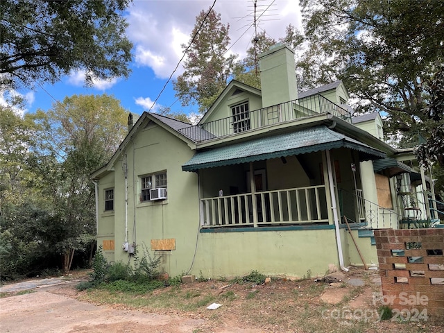 view of home's exterior with a balcony and cooling unit