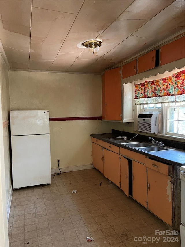 kitchen with white fridge, range, and sink