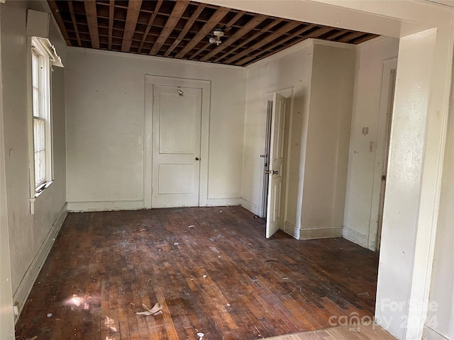 spare room with dark hardwood / wood-style floors