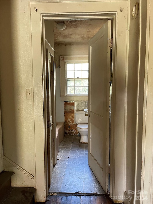 bathroom featuring a bath and toilet