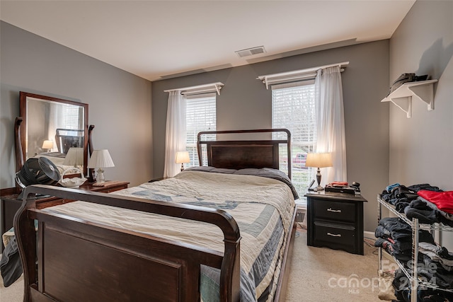 bedroom featuring light colored carpet