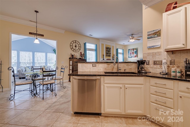 kitchen featuring sink, stainless steel dishwasher, dark stone countertops, tasteful backsplash, and kitchen peninsula