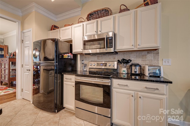 kitchen featuring white cabinets, light tile patterned floors, appliances with stainless steel finishes, and tasteful backsplash