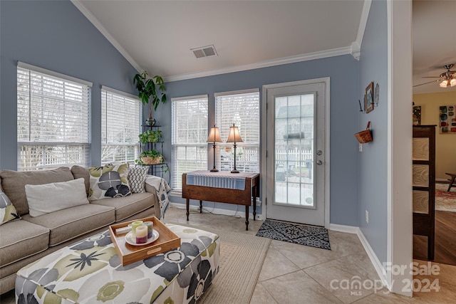 tiled living room with lofted ceiling, ceiling fan, and crown molding