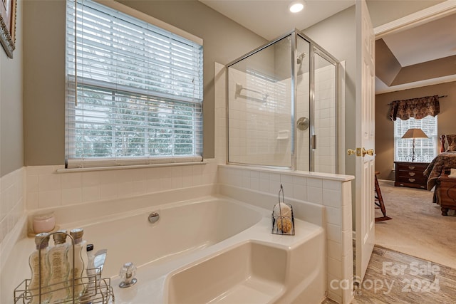 bathroom featuring separate shower and tub