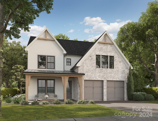 modern farmhouse with covered porch, a garage, and a front yard