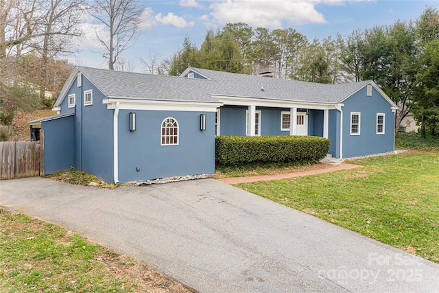 ranch-style home with a front lawn