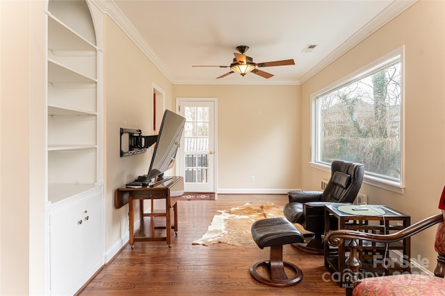 sitting room with ceiling fan, dark hardwood / wood-style flooring, and ornamental molding