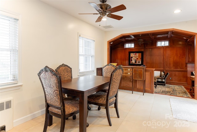 dining room with ceiling fan, radiator heating unit, light tile patterned floors, and vaulted ceiling