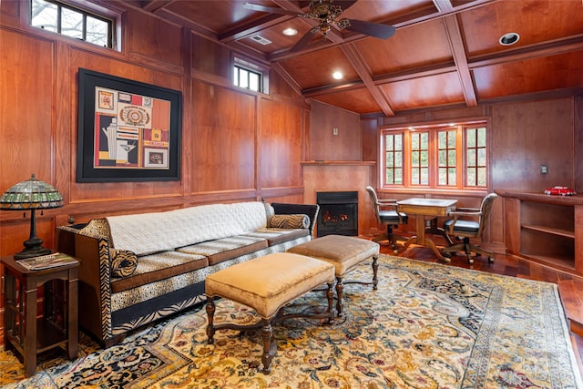 living area with plenty of natural light, wooden walls, and wood ceiling