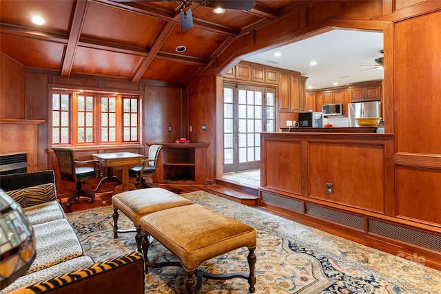 sitting room with beamed ceiling, wooden walls, coffered ceiling, and wood ceiling