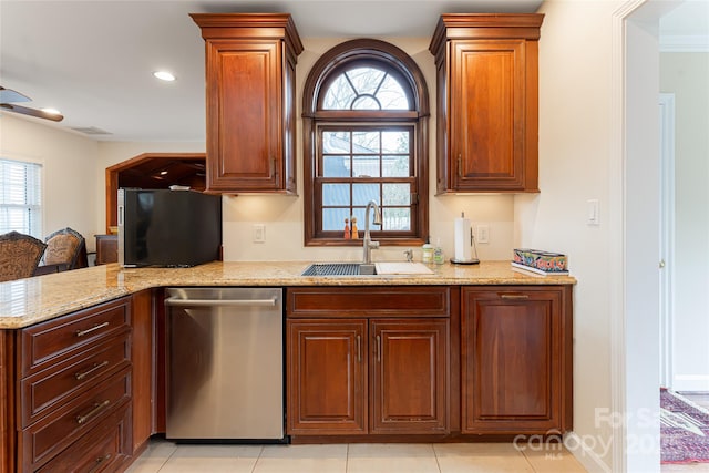 kitchen with light stone countertops, ceiling fan, sink, stainless steel dishwasher, and light tile patterned floors