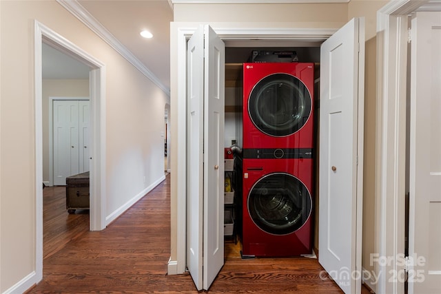 laundry area featuring dark hardwood / wood-style flooring, crown molding, and stacked washer / dryer