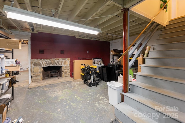 basement featuring a stone fireplace