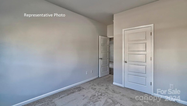 unfurnished bedroom featuring light colored carpet