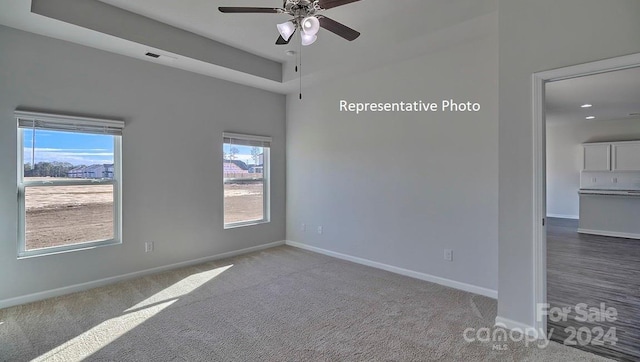 empty room with ceiling fan and carpet floors