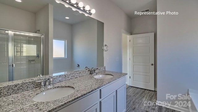 bathroom with hardwood / wood-style flooring, vanity, and independent shower and bath