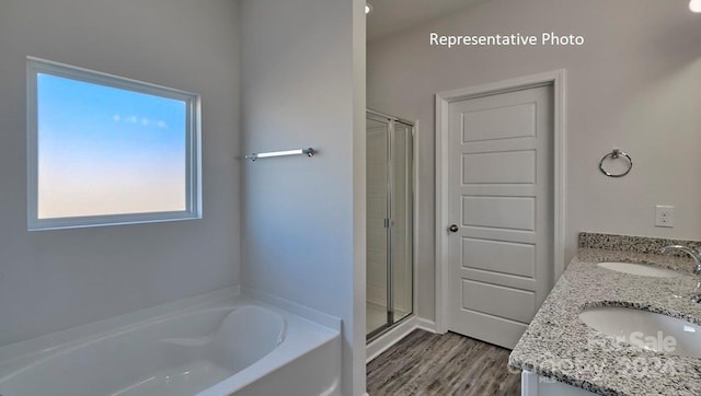 bathroom featuring wood-type flooring, vanity, and independent shower and bath