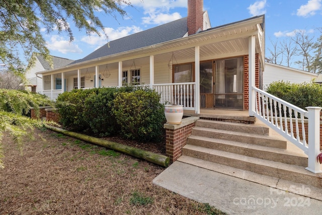 rear view of house with a porch