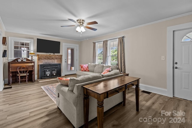 living room with ceiling fan, wood-type flooring, and ornamental molding