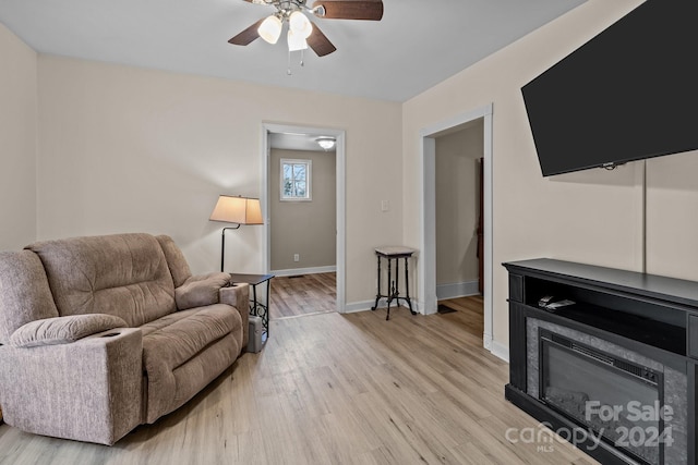 living room with ceiling fan and light hardwood / wood-style floors