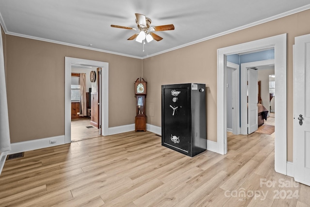 interior space with ceiling fan, light wood-type flooring, and ornamental molding