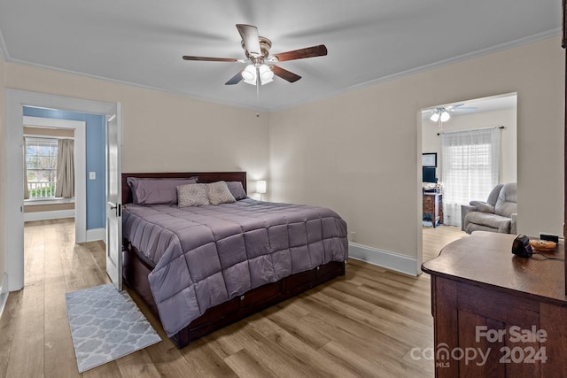 bedroom featuring ceiling fan, ornamental molding, and light wood-type flooring