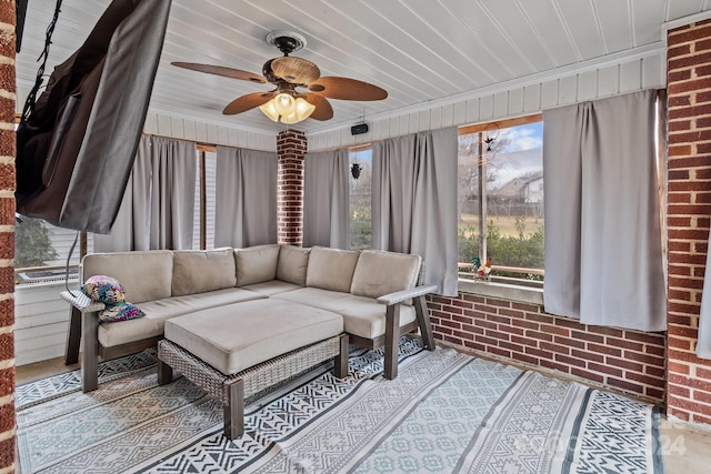 sunroom featuring ceiling fan