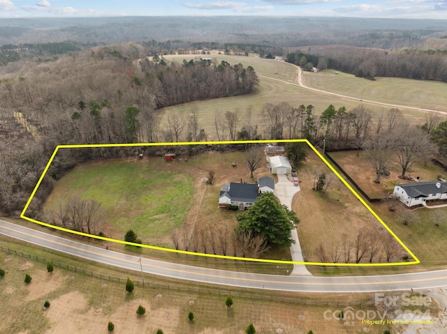 birds eye view of property with a rural view