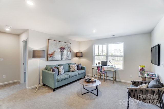 living room featuring recessed lighting, baseboards, and light carpet