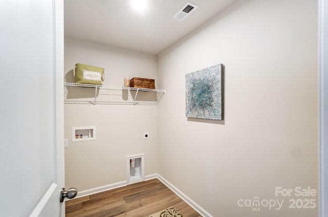 clothes washing area featuring visible vents, laundry area, hookup for a washing machine, wood finished floors, and electric dryer hookup