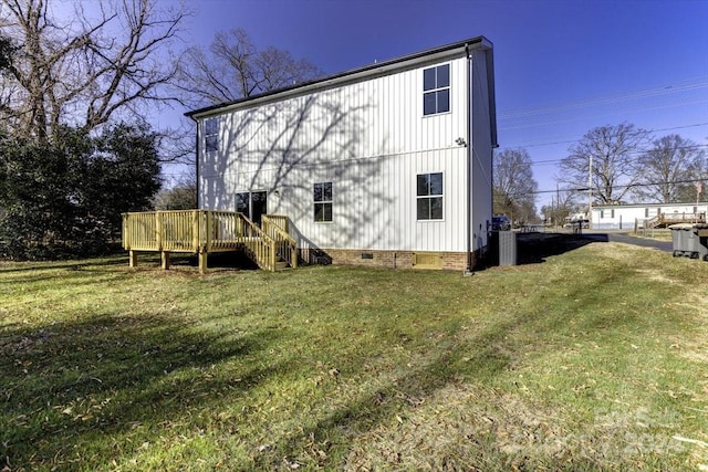 rear view of property with a lawn and a deck