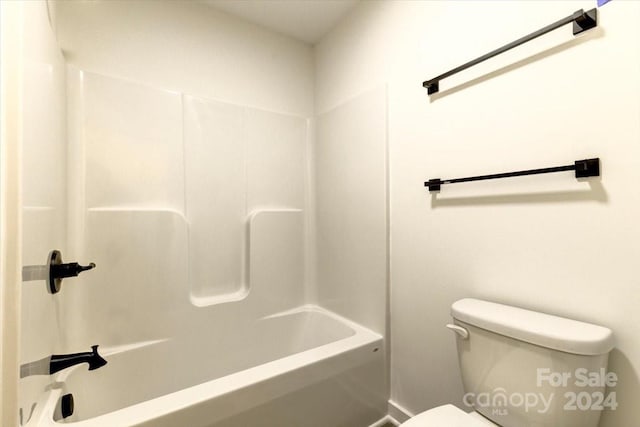 bathroom with bathtub / shower combination and toilet