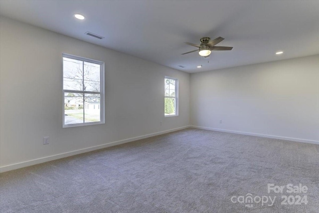 spare room with ceiling fan and carpet floors