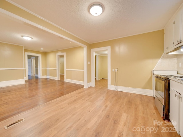 interior space with crown molding, light hardwood / wood-style floors, and a textured ceiling