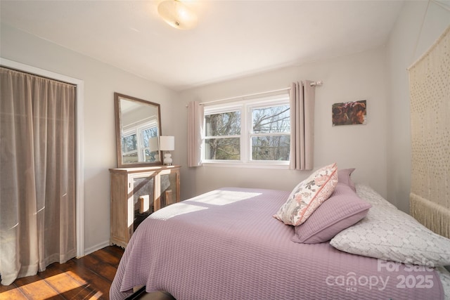 bedroom with dark hardwood / wood-style floors