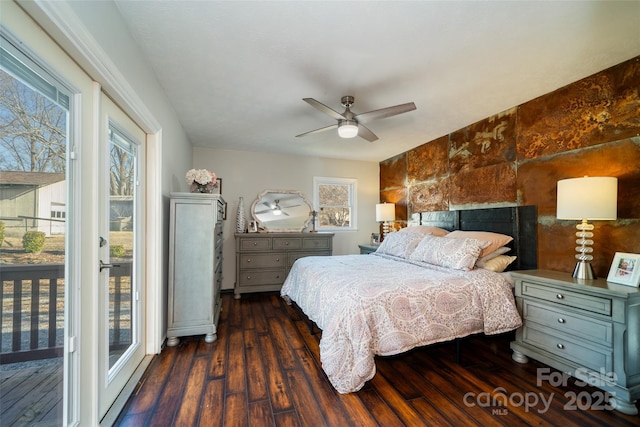 bedroom with ceiling fan, dark hardwood / wood-style floors, and access to outside