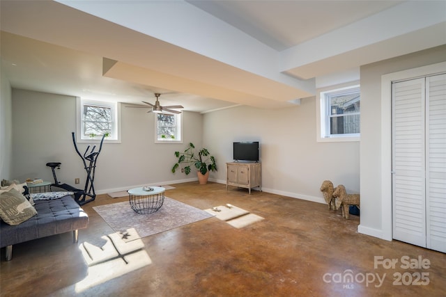 living room featuring concrete flooring and ceiling fan