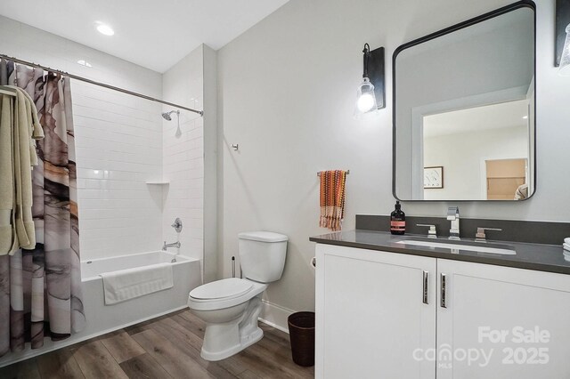 full bathroom featuring shower / bath combo with shower curtain, vanity, wood-type flooring, and toilet