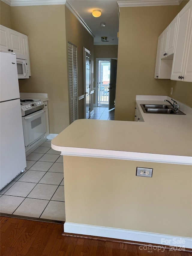 kitchen featuring kitchen peninsula, white appliances, white cabinetry, and sink