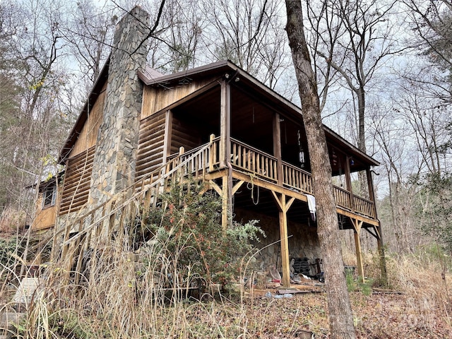 back of house featuring a wooden deck